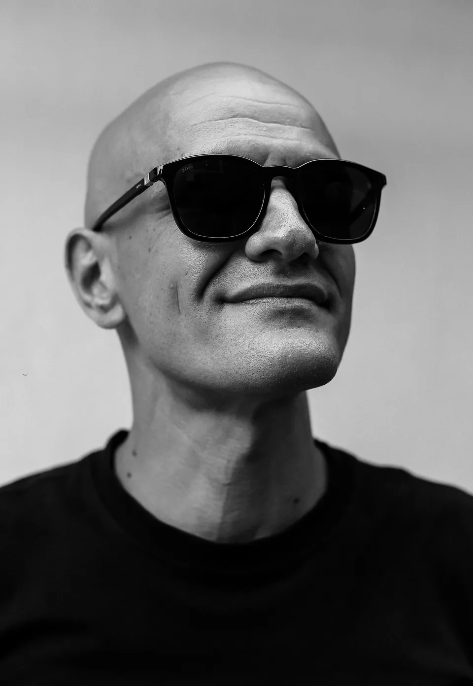 Monochrome close-up portrait of GANGSTANTIN wearing sunglasses.
