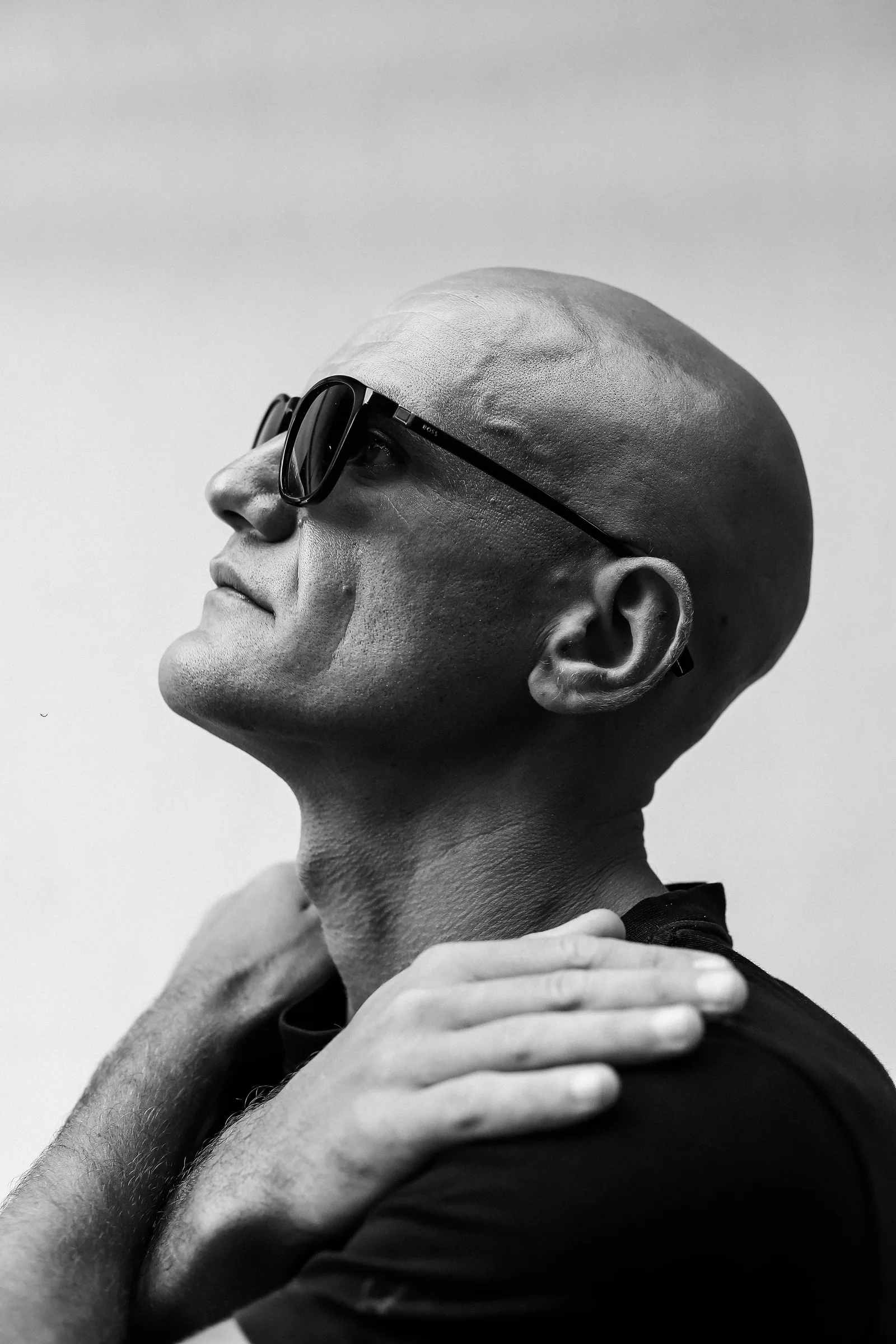 Monochrome profile portrait of GANGSTANTIN wearing sunglasses.